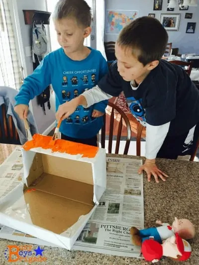 young boys painting box for creative learning fun