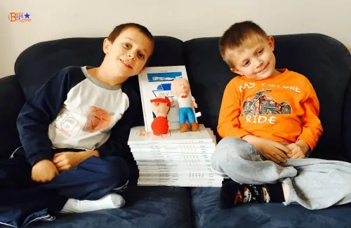 young boys with stack of Life of Fred readers and dolls