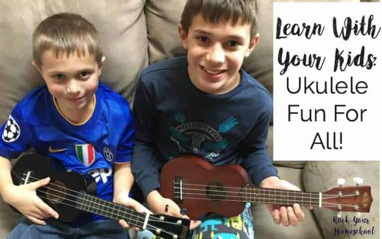 2 boys holding ukuleles