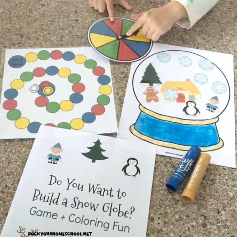 Boy using spinner to play Do You Want to Build a Snow Globe? game for fun winter activity for kids.