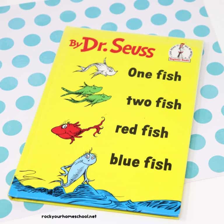 One fish two fish red fish blue fish book by Dr. Seuss book on light blue polka dot paper.