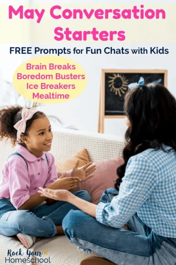 African American girl wearing pink shirt and overalls &amp; pink head band smiling at mom with blue gingham shirt &amp; jeans while sitting on couch with white blanket &amp; chalkboard with sun in background