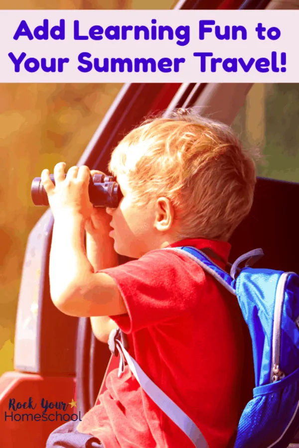 Boy wearing red shirt using black binoculars looking out car window