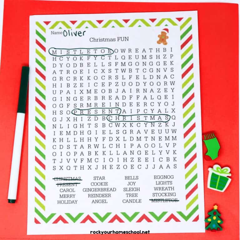 Christmas Fun Word Search with black marker and holiday-themed erasers on red background.