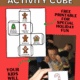 Free printable page of gingerbread activity cube and mom holding cube with boys in background pretending to be a candy cane to feature how you can use this free gingerbread activity cube printable.