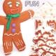 Smiling gingerbread man cookie with gingerbread house and gingerbread tree on snow background