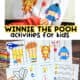 Young boy using scissors with Winnie the Pooh puzzle and examples of free Winnie the Pooh printables with crayons.