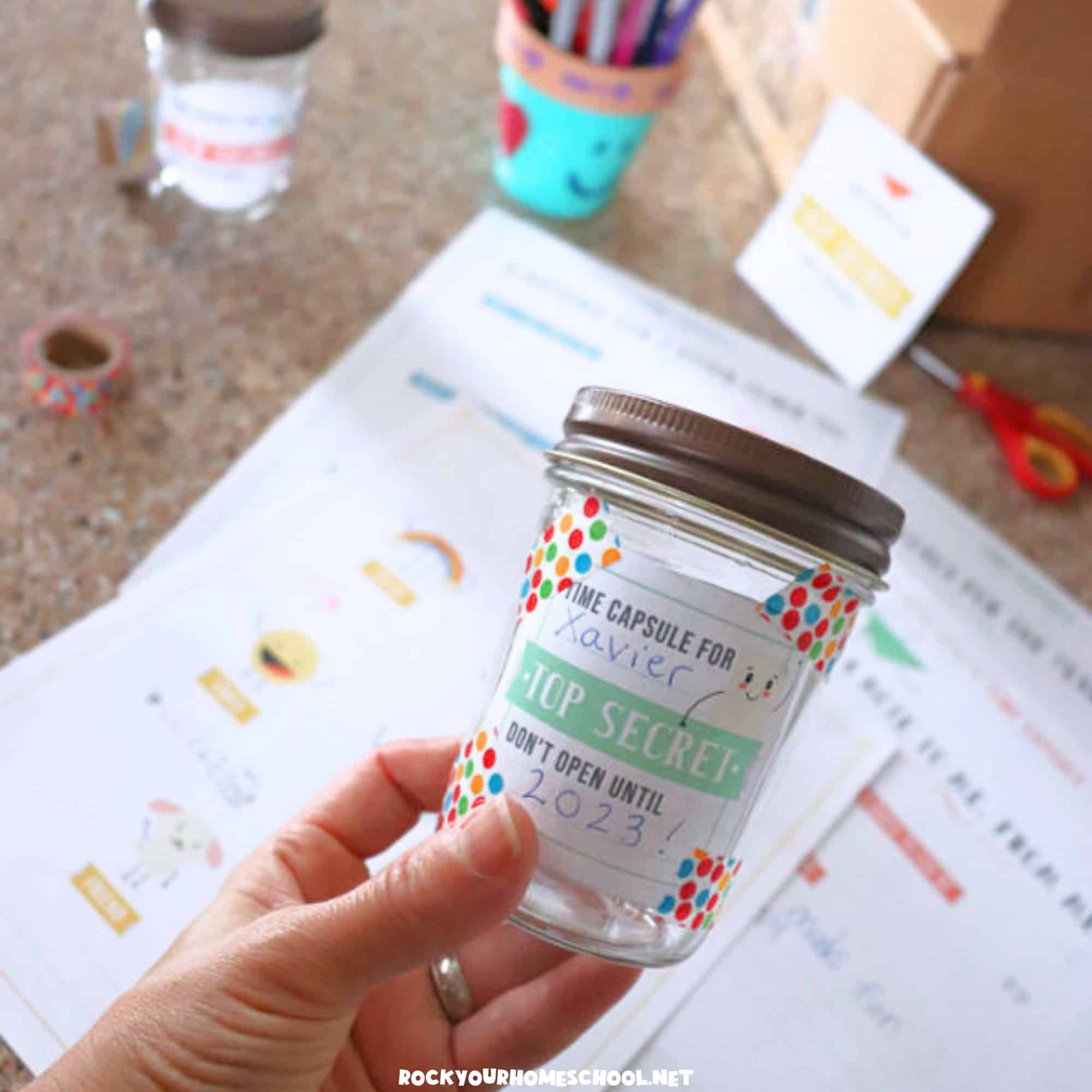 Person holding example of time capsule for kids with cute label.