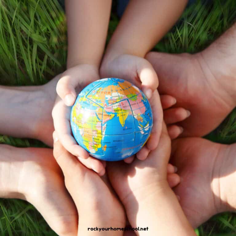 Children holding planet Earth ball.
