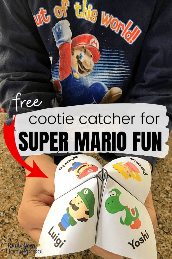 Boy holding Super Mario cootie catcher & wearing a Super Mario shirt to feature the amazing fun your kids will have with this free cootie catcher