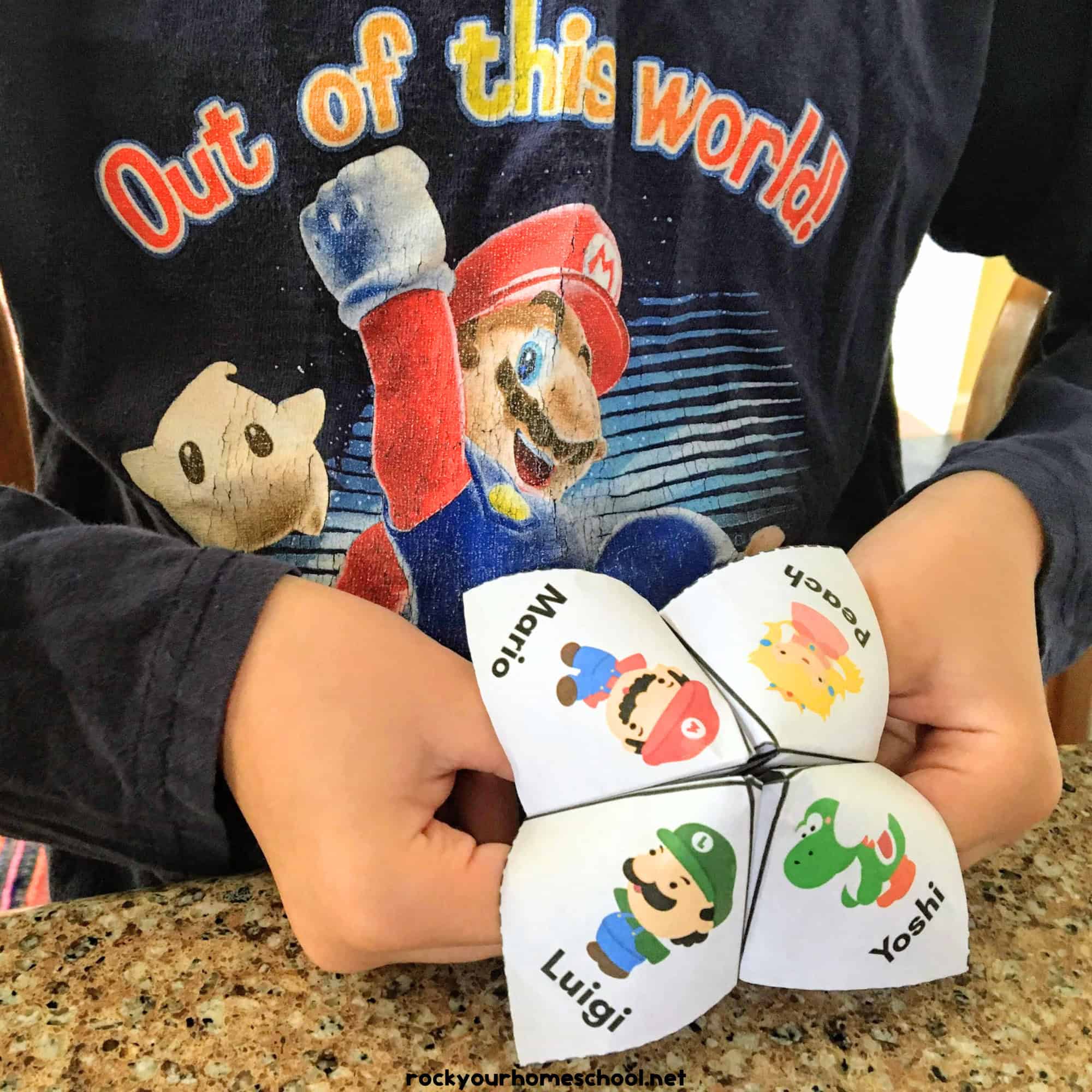 Boy holding Super Mario cootie catcher.