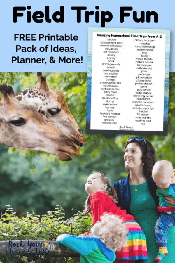 Mom, daughter, & baby smiling & looking up at two giraffes while on a field trip