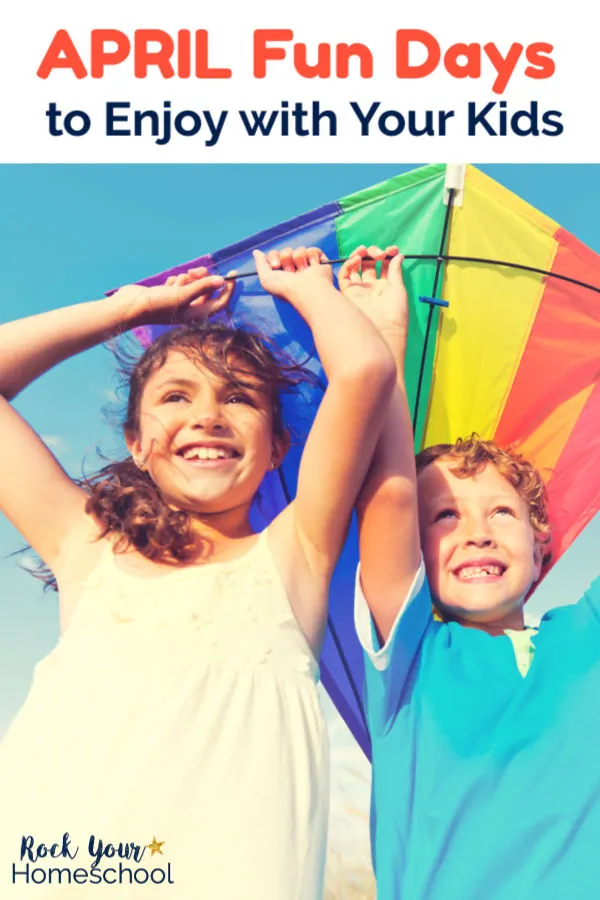 Sister & brother smiling and holding a rainbow kite with blue sky background for April Fun 