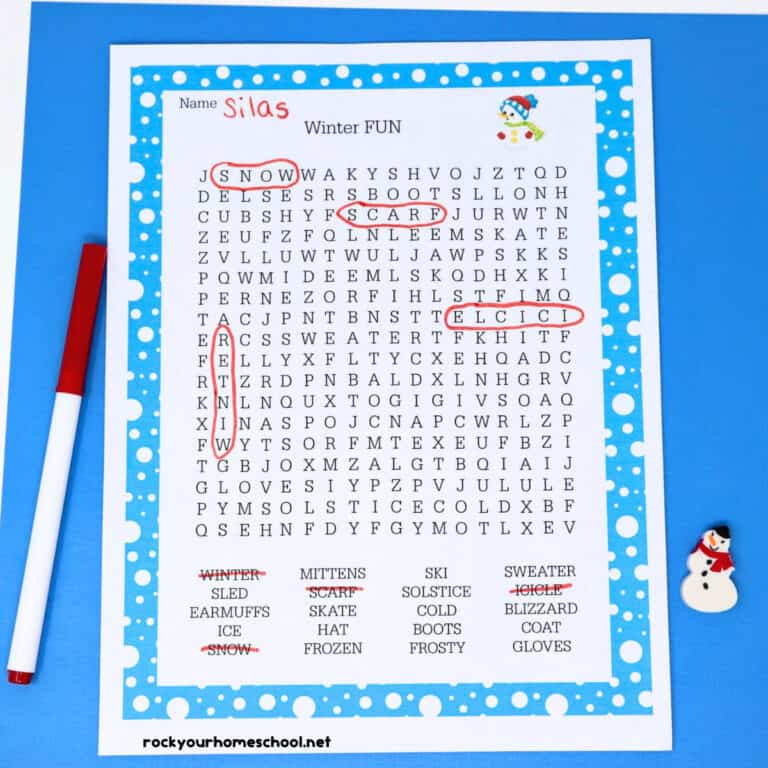 Winter Word Search printable page with red marker & snowman mini-eraser on light blue paper & red mittens and red ear muffs clipart.