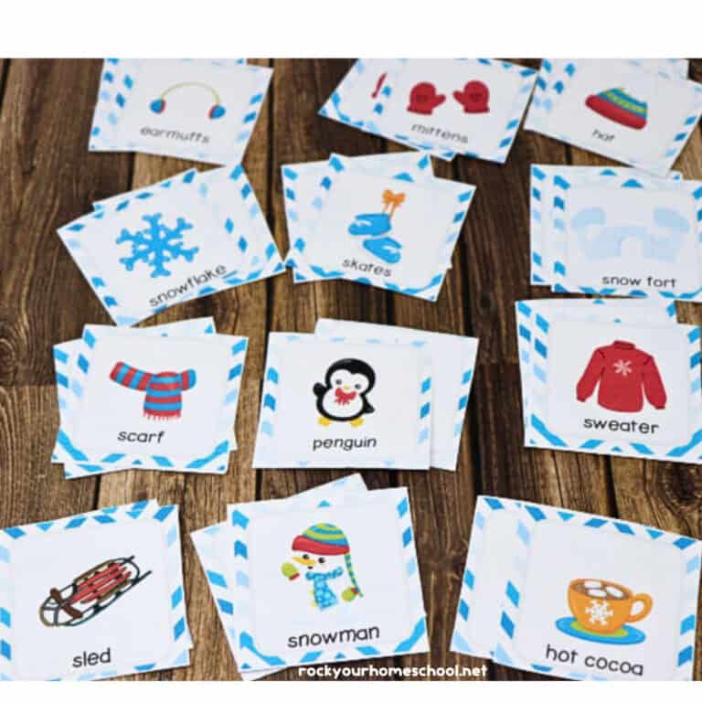 Winter Memory Game for kids cards on wood background and woman holding cookies & cocoa Winter Memory Game cards with other cards in background.