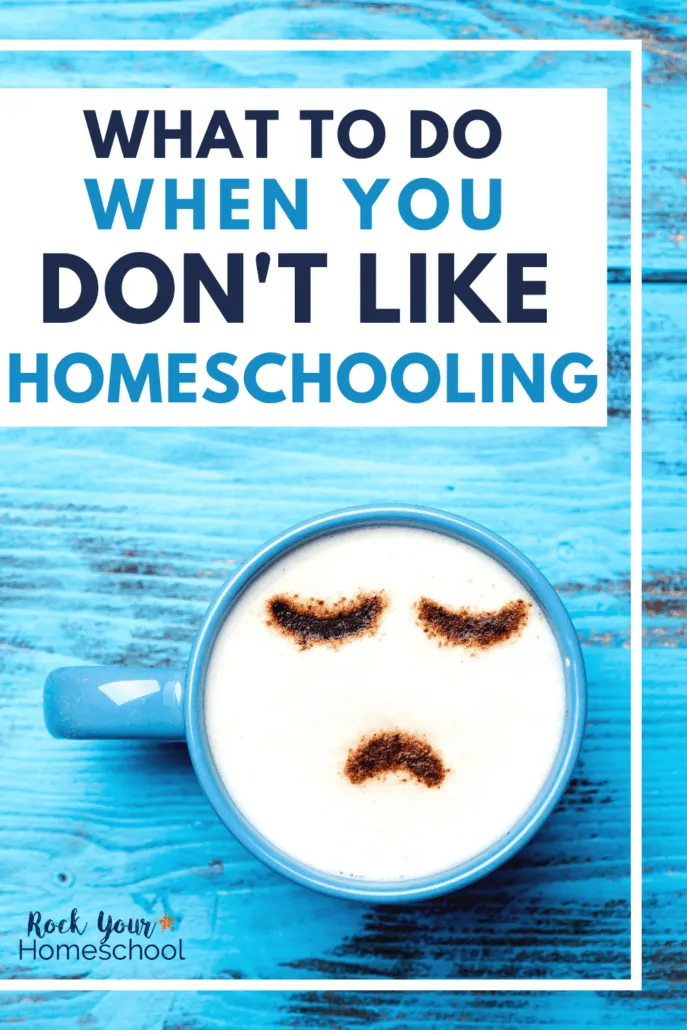 Blue mug of coffee with white froth & cocoa powder sad face to feature what it feels like when you don't like homeschooling