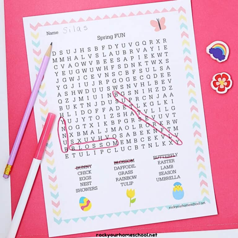 Free Spring Fun Word Search and pink marker & light purple pencil & mini-erasers on pink paper.