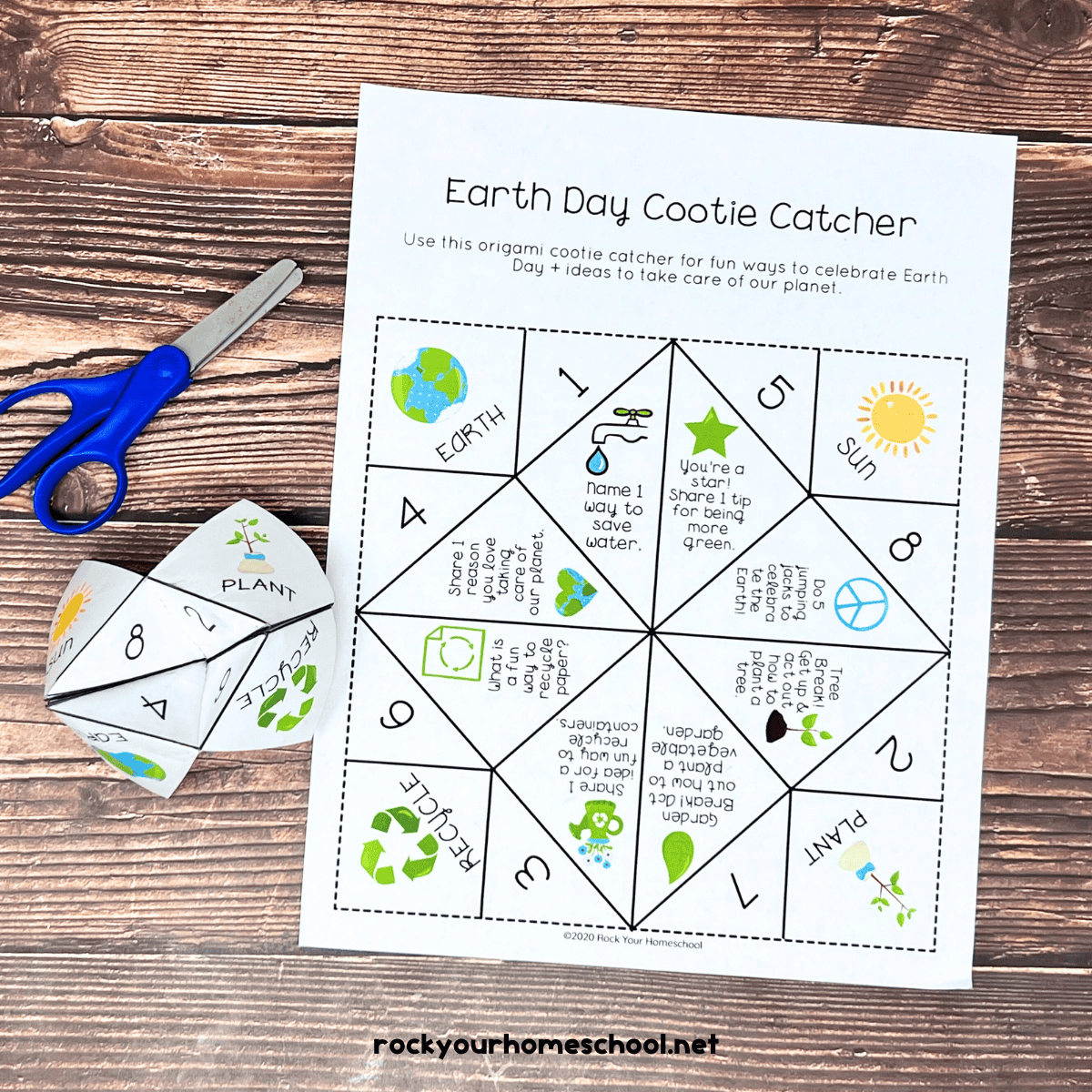 Free printable page of Earth Day cootie catcher and folded version with blue scissors.