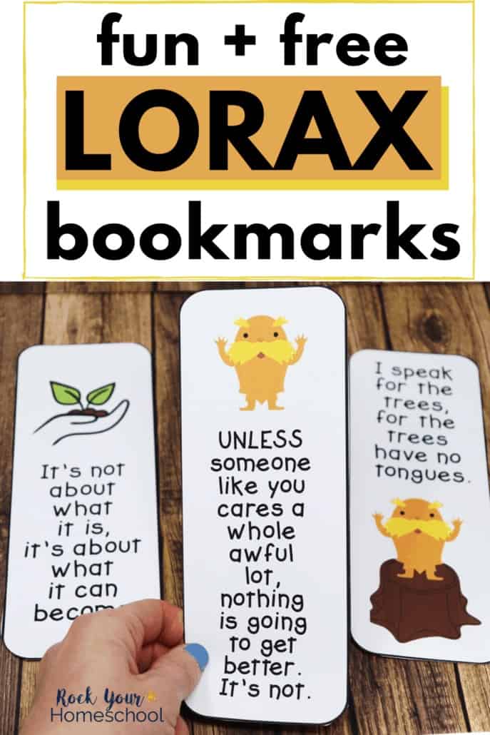 Woman holding 3 free Lorax bookmarks to feature the learning fun your kids will enjoy