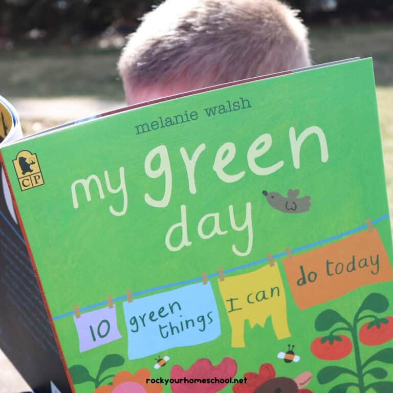 Boy reading My Green Day from Candlewick Press on a sunny day to feature the variety of Earth Day ideas and resources you can use for a fun mini-unit study with your kids to celebrate the 50th Anniversary of Earth Day