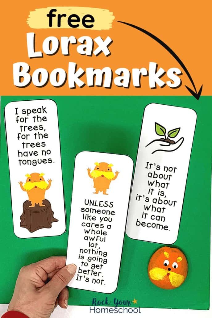 Woman holding The Lorax bookmarks to feature the reading fun you have have with these free Dr. Seuss printables