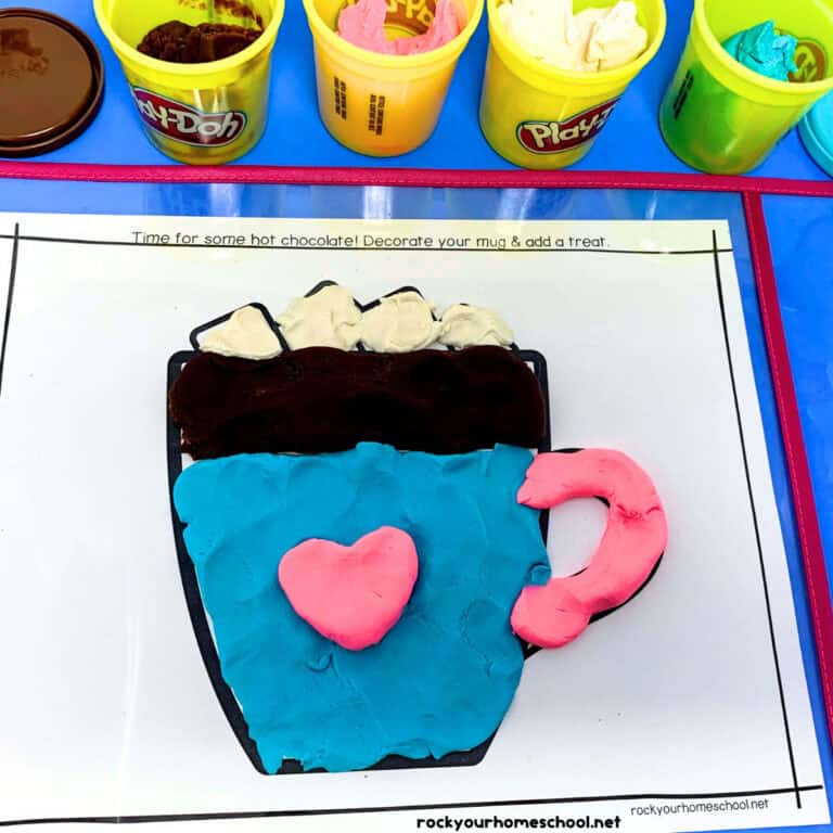 Example of winter playdough mat featuring hot cocoa with cans of play-doh.