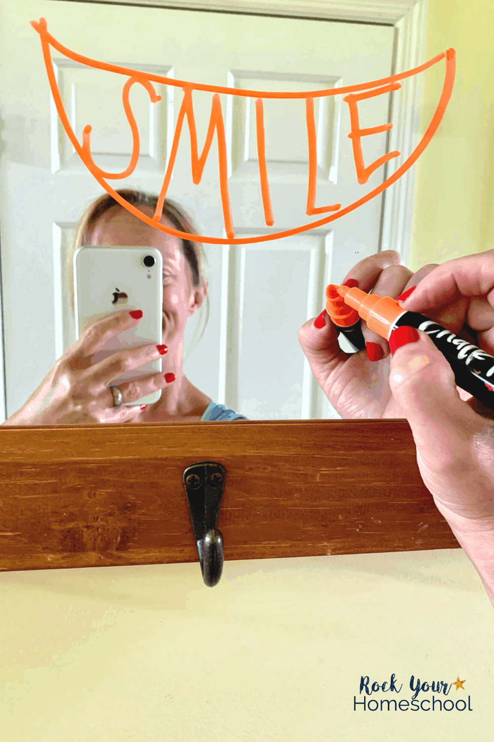 Mom writing the word SMILE on mirror with chalk marker from Chalkola