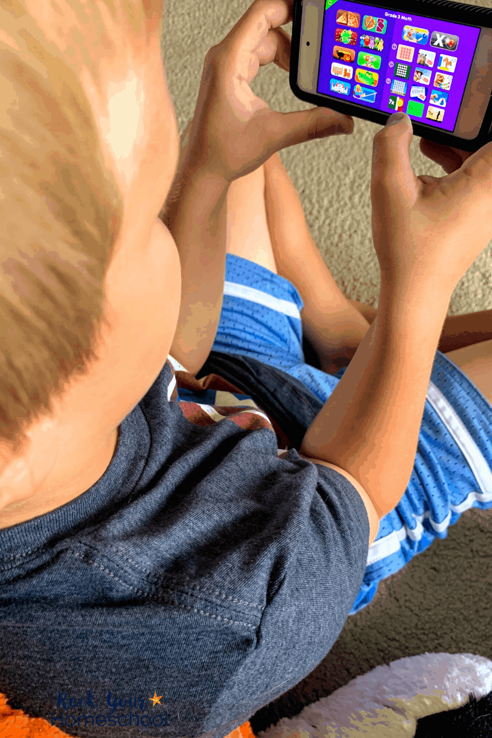 Young boy using the Starfall app on iPod for Grade 3 math