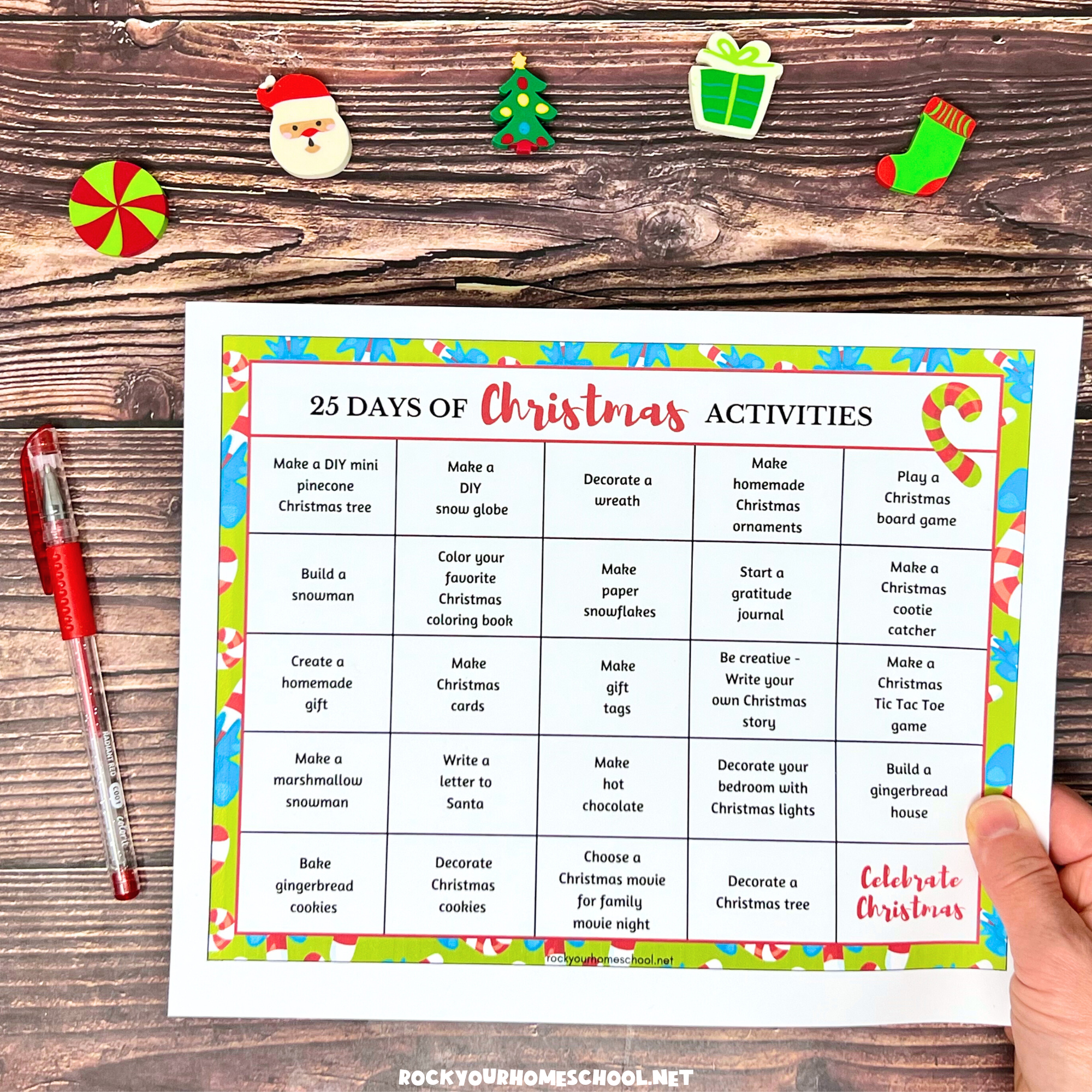 Woman holding free printable chart of 25 days of Christmas activities.