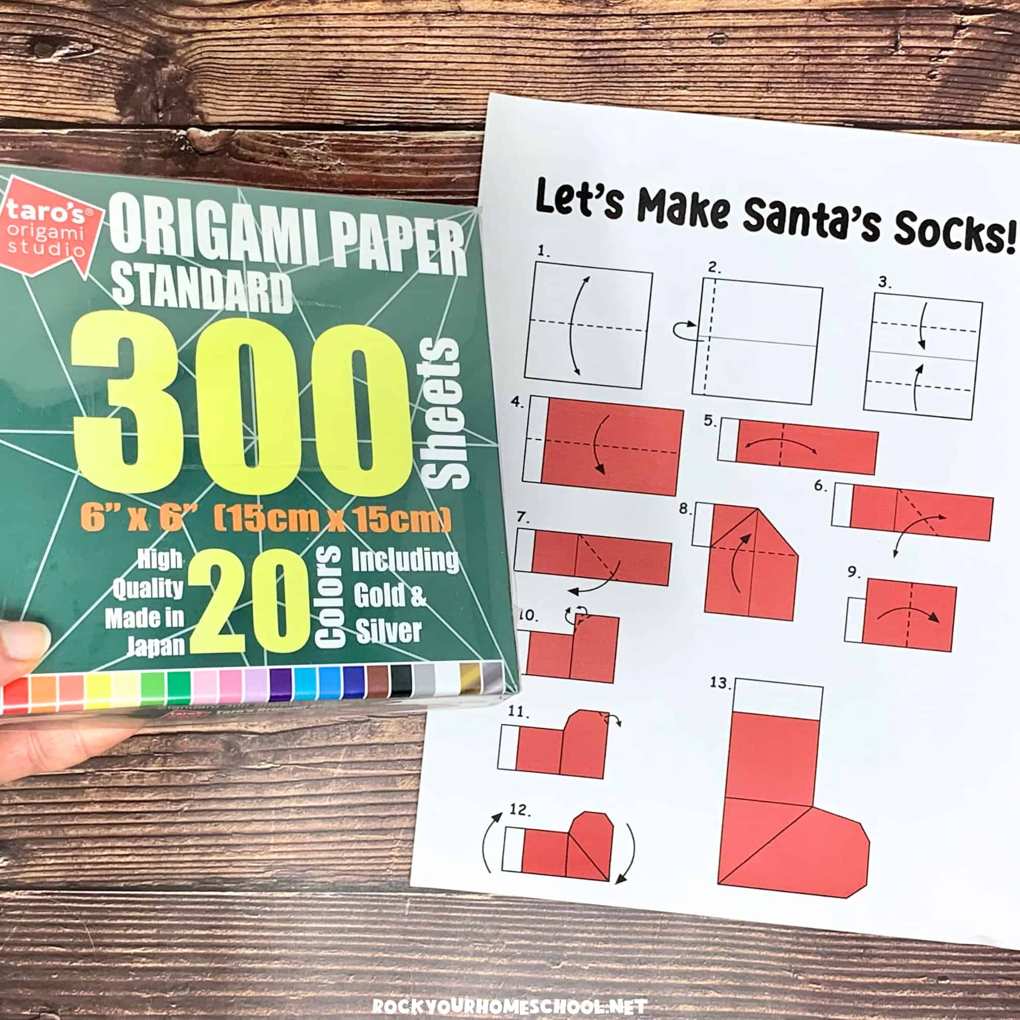 Free printable Christmas origami instructions for Santa's socks and woman holding pack of origami paper.