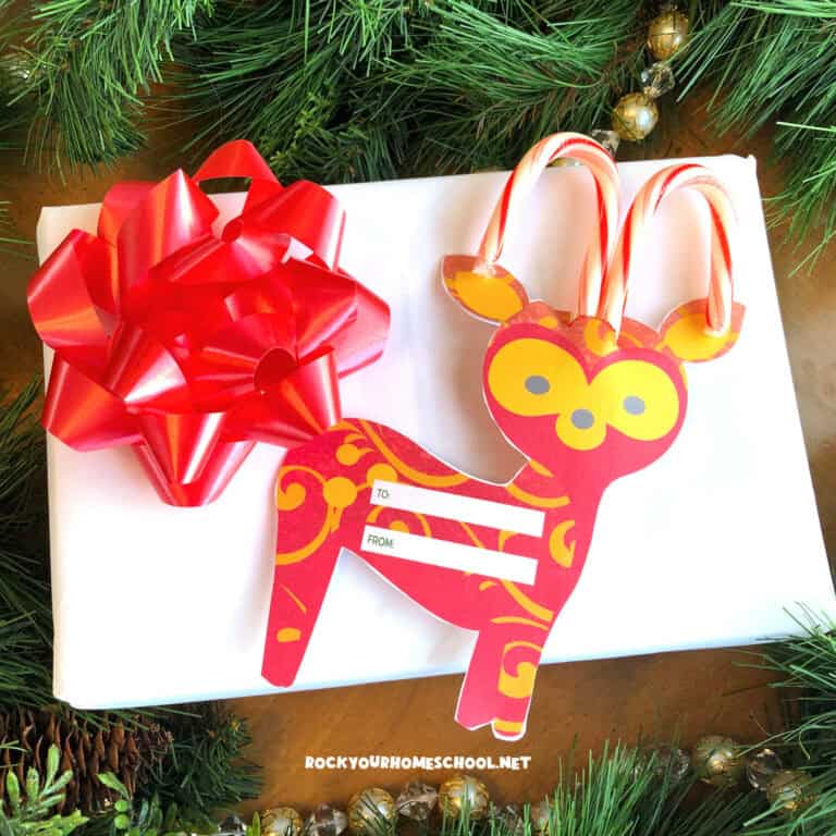 Example of free printable Christmas gift tag featuring reindeer with candy cane antlers.