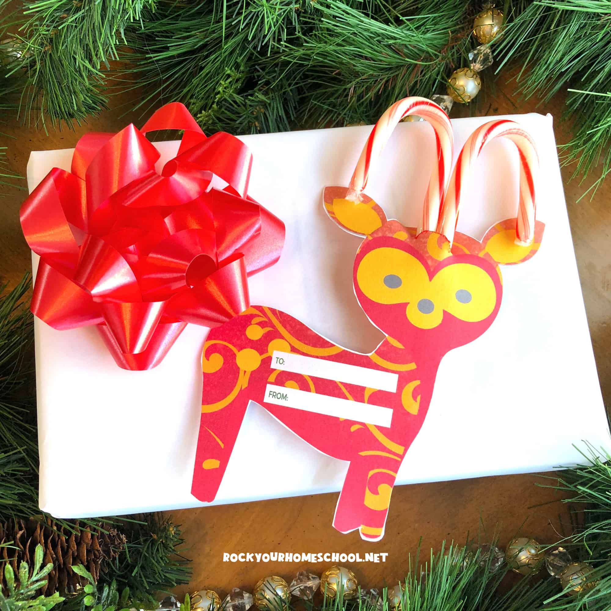 Example of free printable Christmas gift tag featuring reindeer with candy cane antlers.