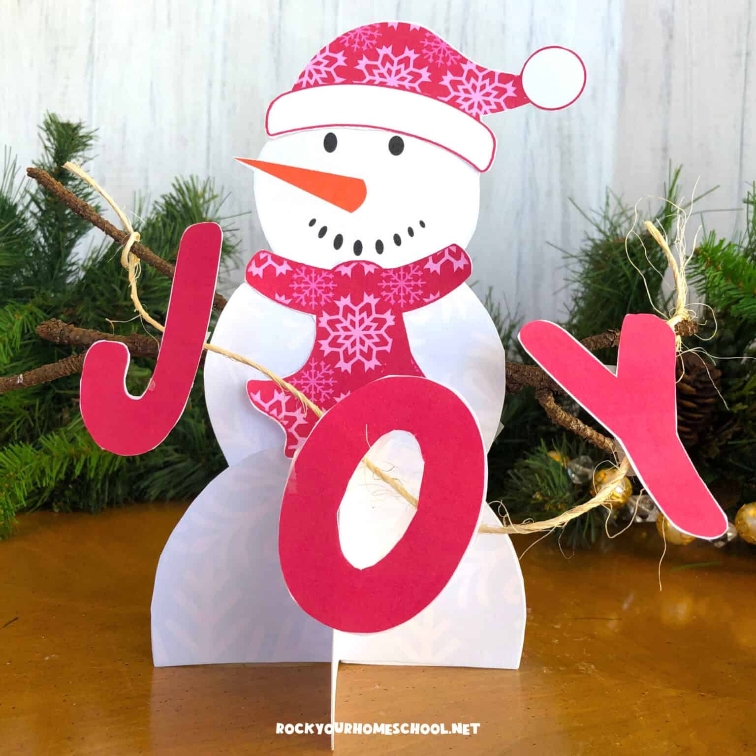 Example of free printable paper snowman craft with word JOY.