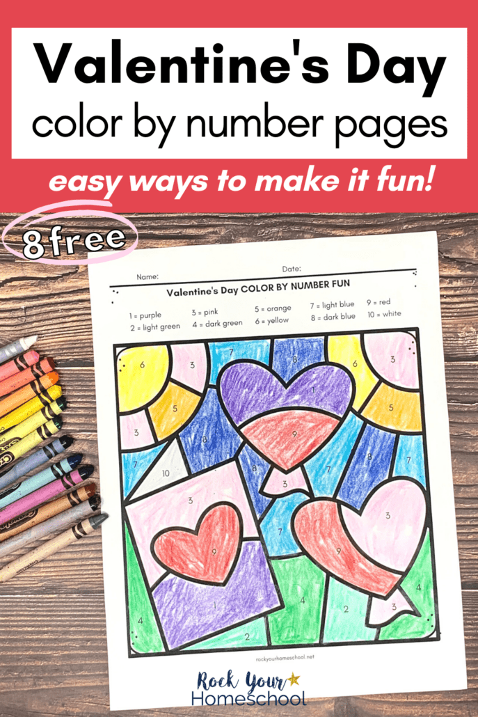 Valentine's Day color by number page featuring card with heart and heart balloons with crayons on wood background