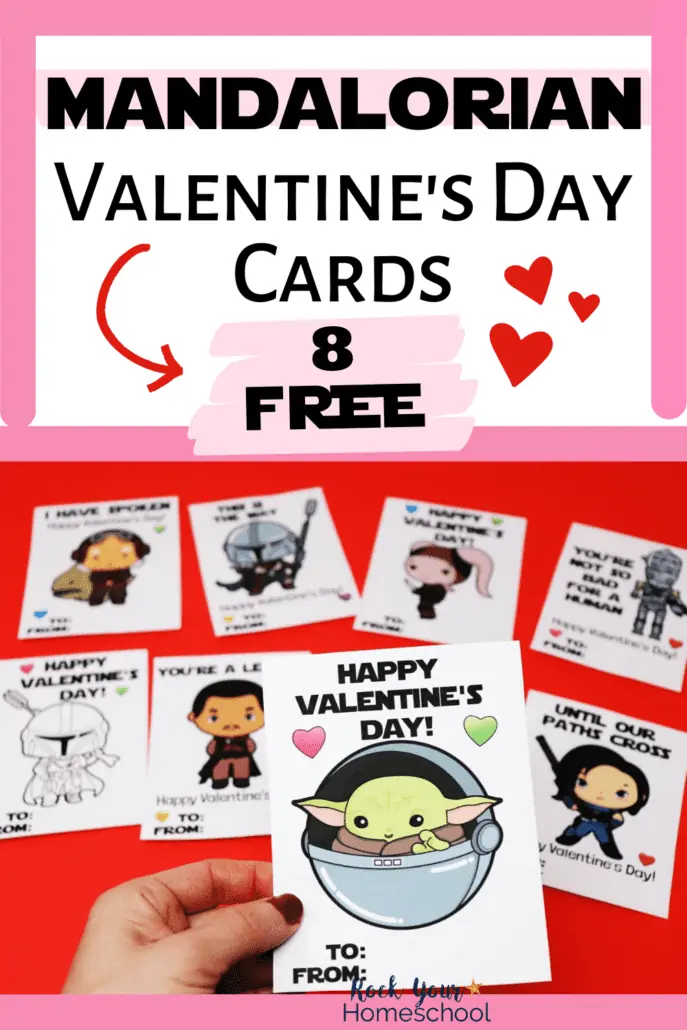 woman holding free printable Mandalorian Valentine's Day card featuring Baby Yoda with other cards on red background