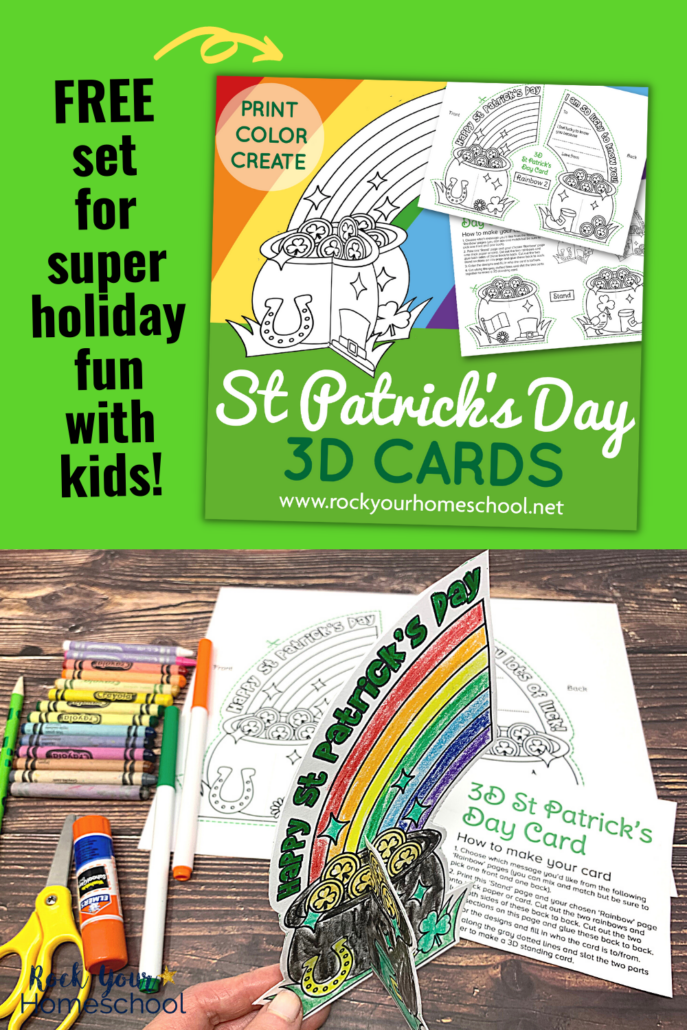 Woman holding free printable 3D St. Patrick's Day card with rainbow and pot of gold plus other St. Patrick's Day themes with crayons, markers, green pencil, glue stick, and yellow scissors on wood surface
