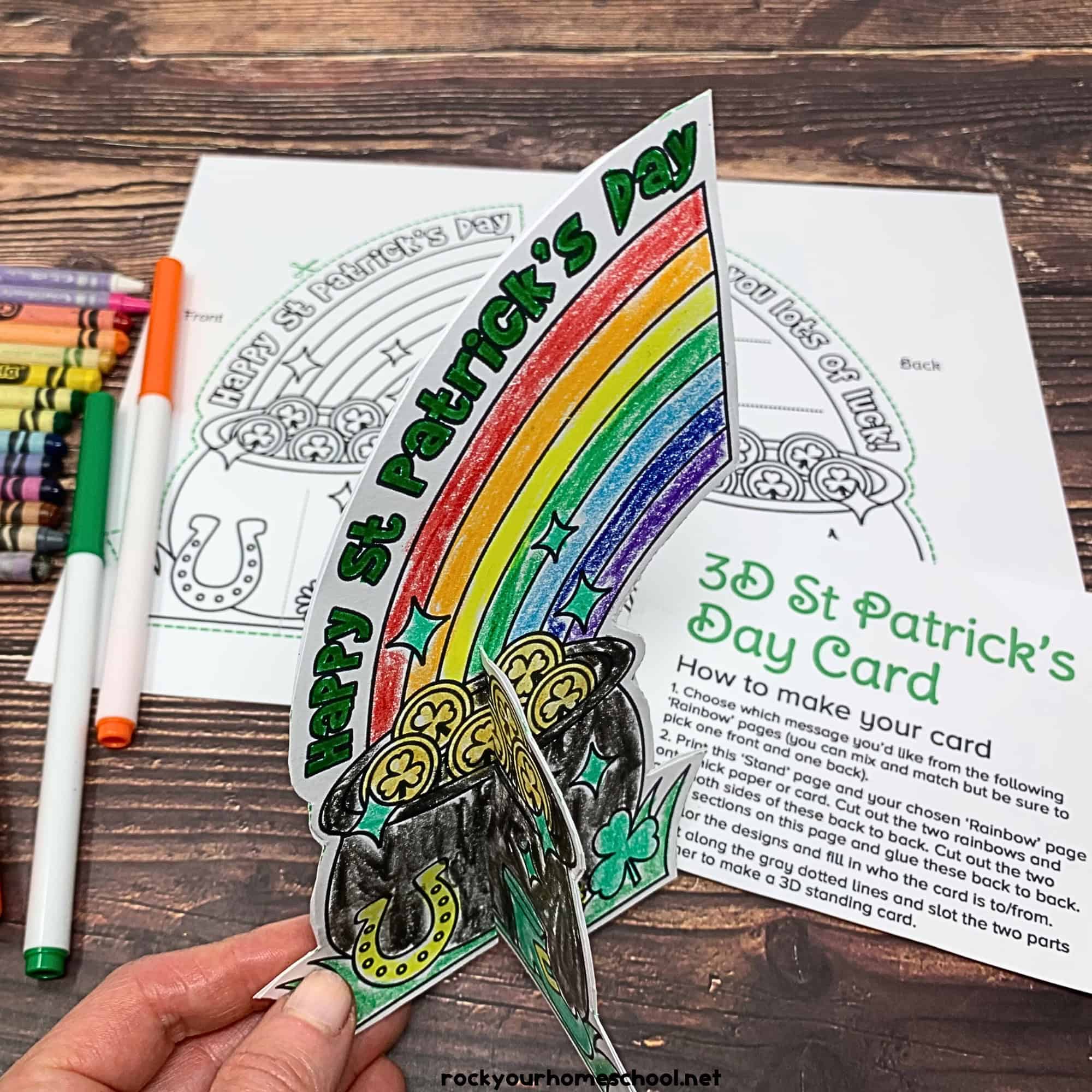 Woman holding free printable St. Patrick's Day 3D card for coloring fun.