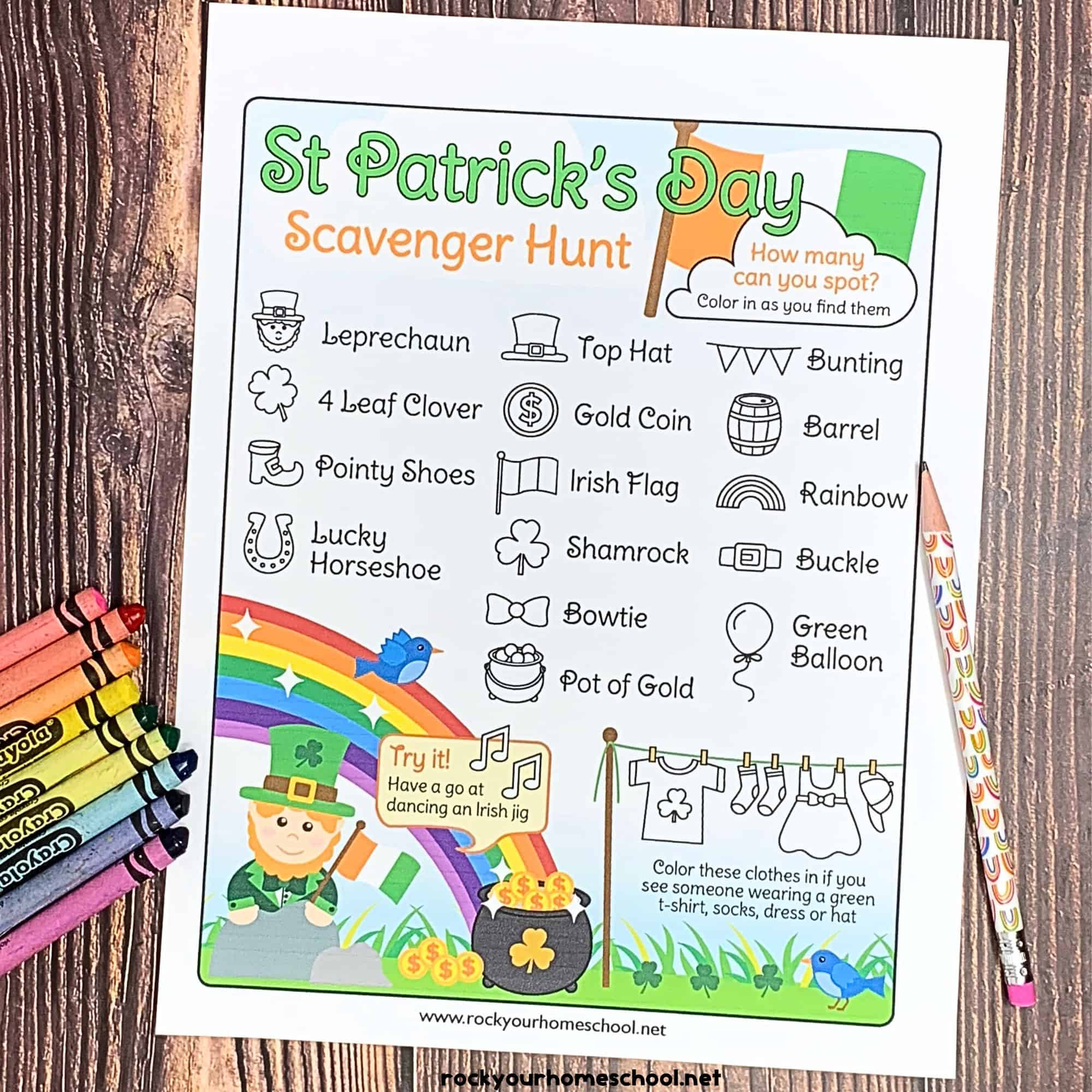 free printable St. Patrick's Day scavenger hunt with crayons and pencils with rainbows on wood surface.