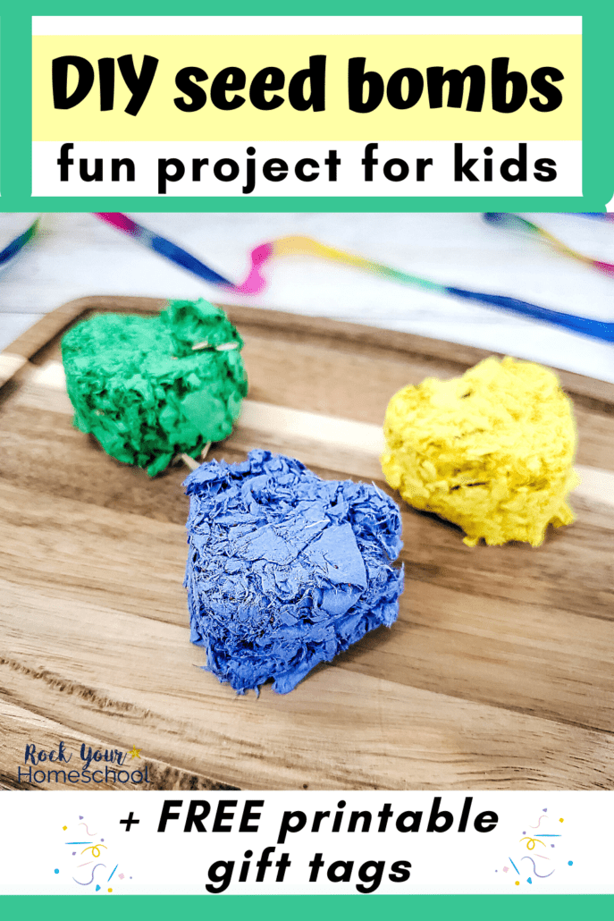 3 heart-shaped seed bombs in green, yellow, and blue on wood cutting board to feature this simple project for kids that includes free printable gift tags