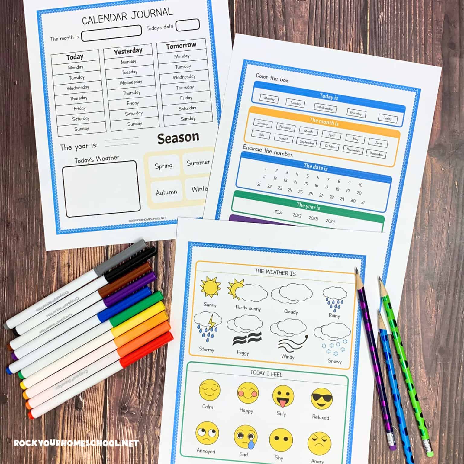 3 free printable student calendar pages on wood background with rainbow of markers and pencils.