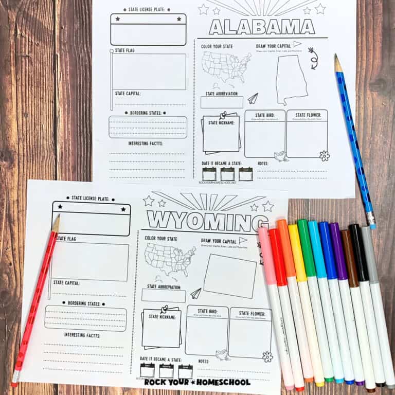 Alabama and Wyoming printable pages with red and blue pencils and rainbow of markers on wood background to feature this free set of 50 States printable activities for geography fun.