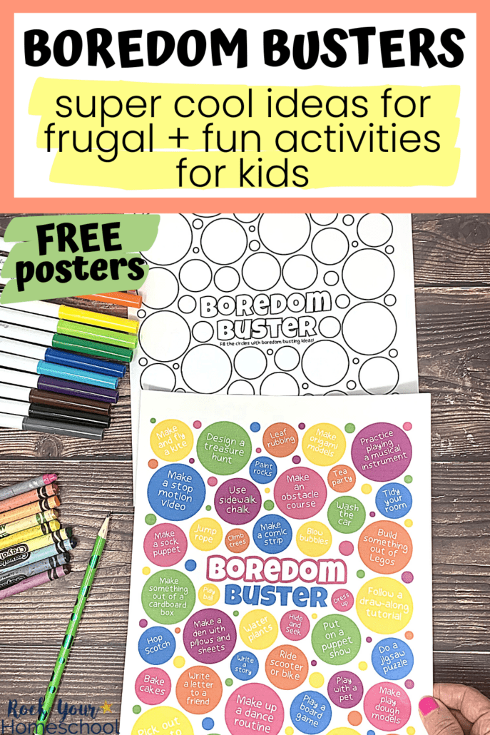 Woman holding free printable color boredom buster poster with black-and-white version, rainbow of markers, crayons, and pencil on wood background