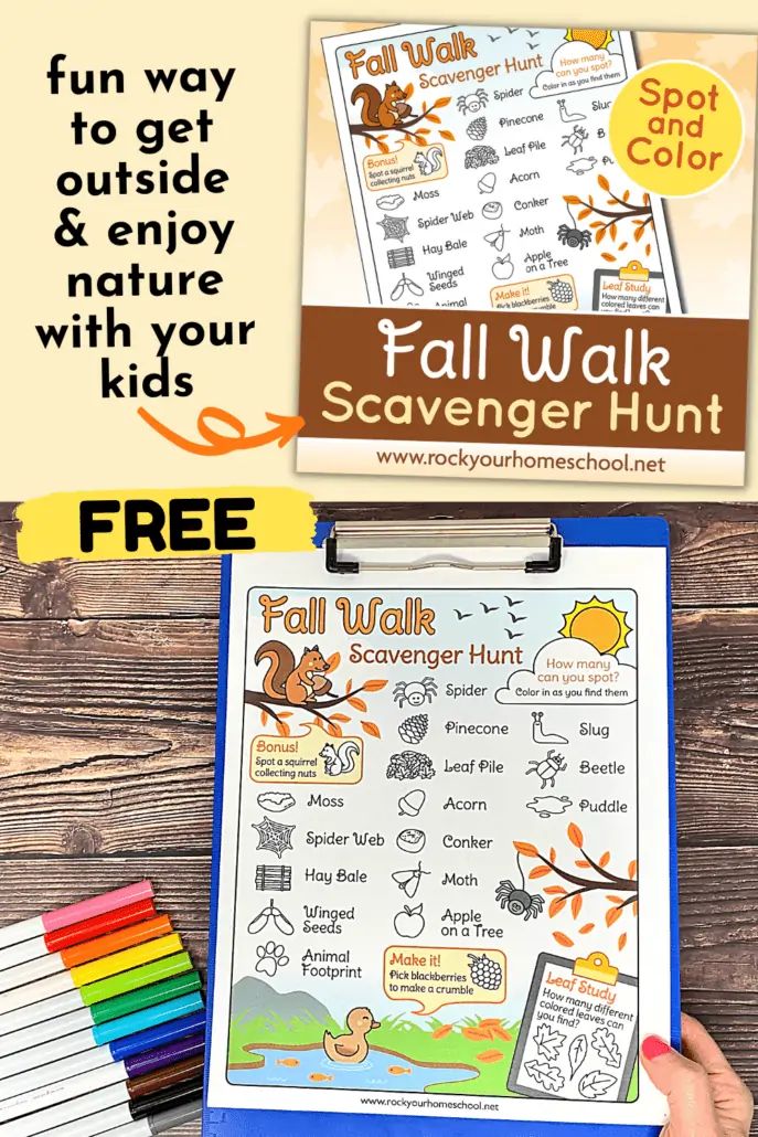 woman holding free printable fall walk scavenger hunt on blue clipboard with rainbow of markers on wood background