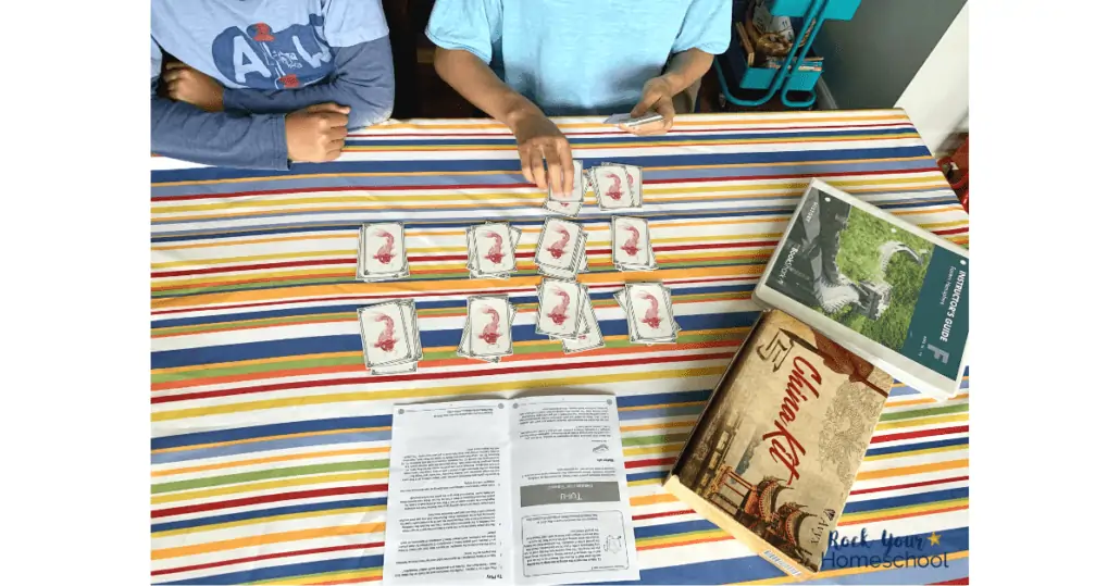 teen and tween boy using domino cards found in the China Kit from BookShark Reading with History F