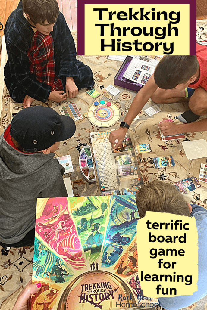 Woman holding Trekking Through History board game with 4 boys playing it in the background on a carpet