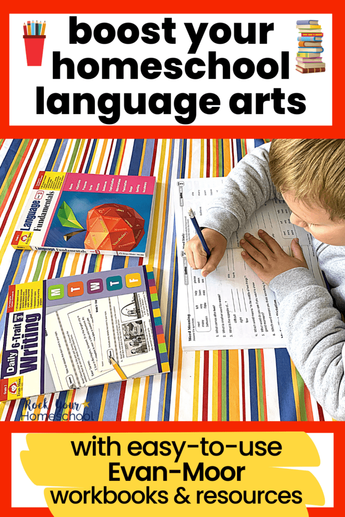Young boy using blue pencil to work in a spelling skills workbooks with other Evan-Moor workbooks for language arts in the background