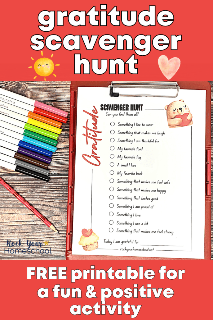 free printable gratitude scavenger hunt on red clipboard with red pencil and rainbow of markers on wood background