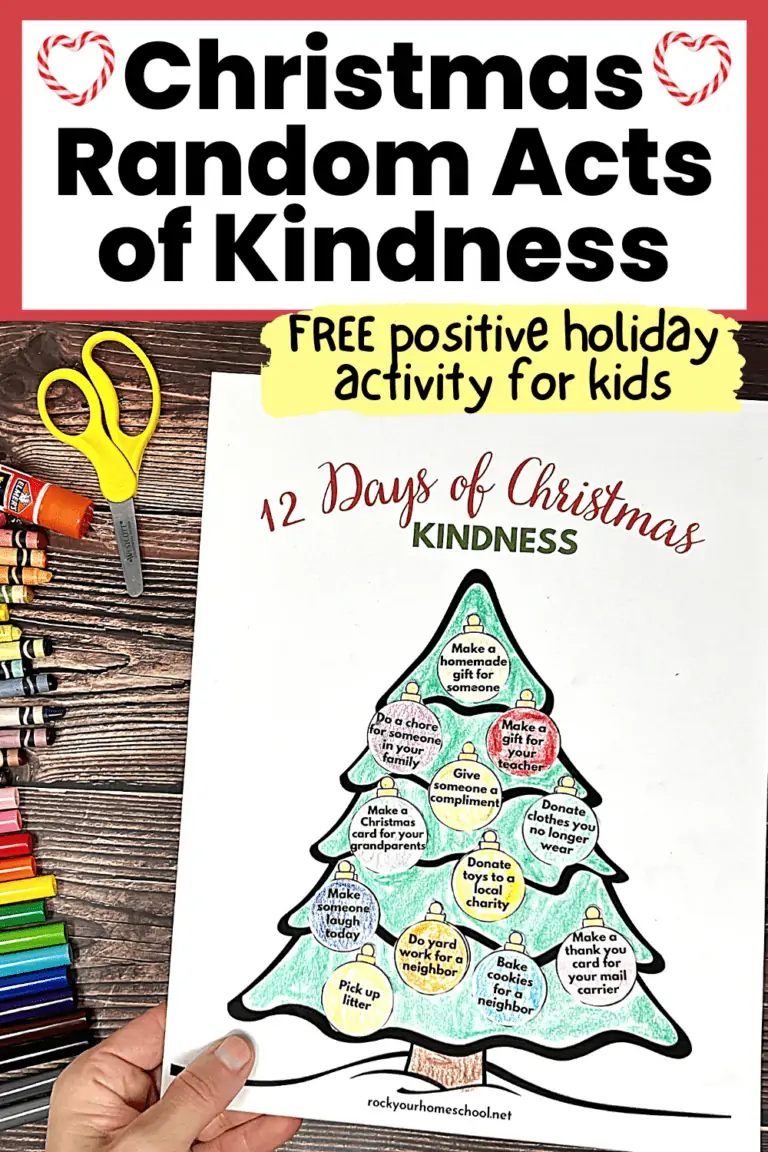 woman holding 12 Days of Christmas Random Acts of Kindness activity featuring Christmas tree and ornaments with prompts with rainbow of markers, crayons, glue stick, and yellow scissors on wood background