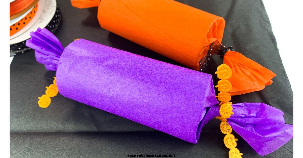 Two examples of DIY Halloween party poppers in orange and purple.