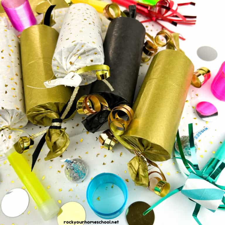 Examples of DIY New Year's Eve Party Poppers in tissue paper of gold sparkle, gold, black with ribbons, confetti, and party favors for kids.